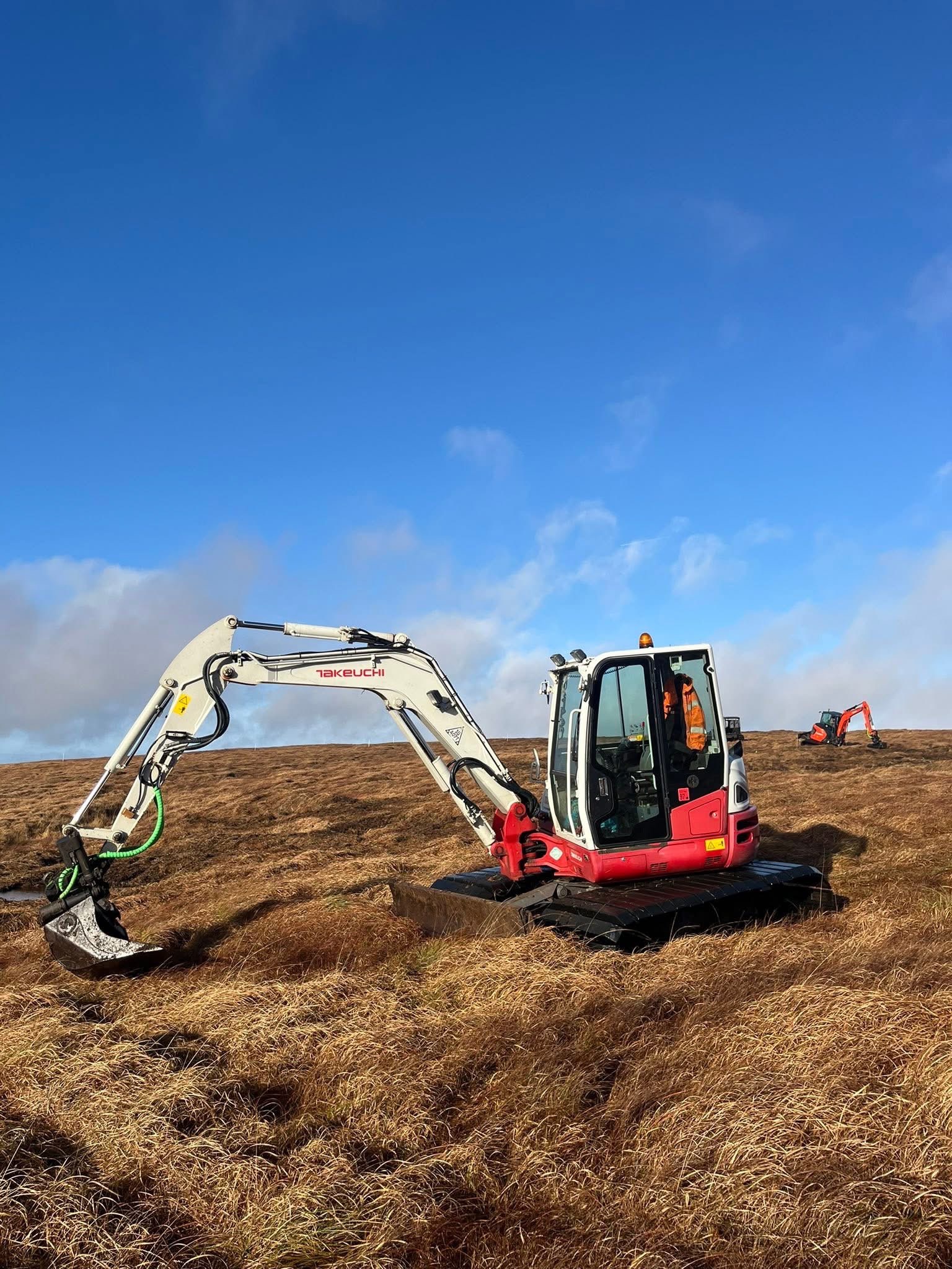 Excavators working on Dartmoor blanket bog peatland restoration