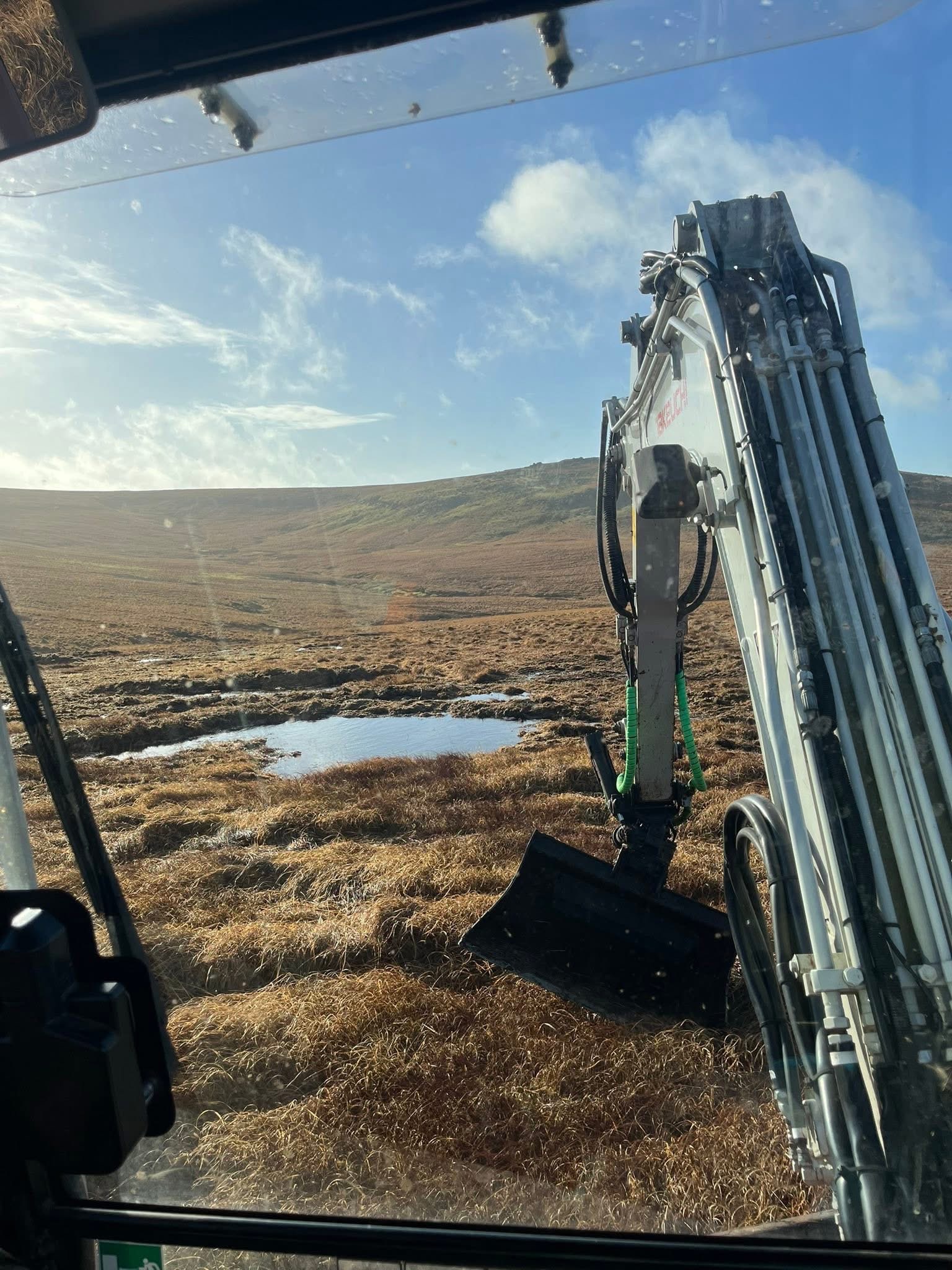 View from excavator cab across Dartmoor restoration site