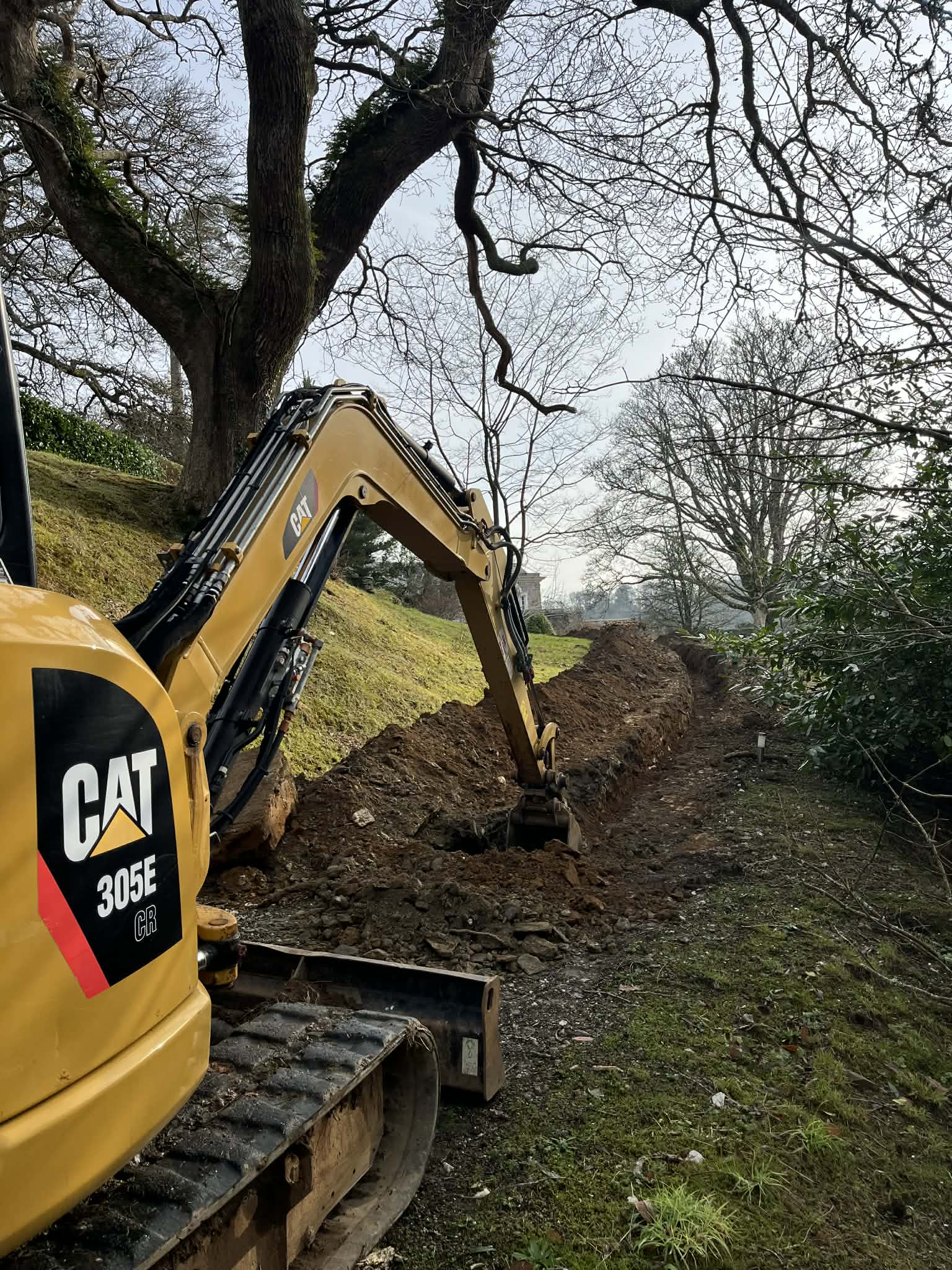 Excavator operating during groundwork and land shaping