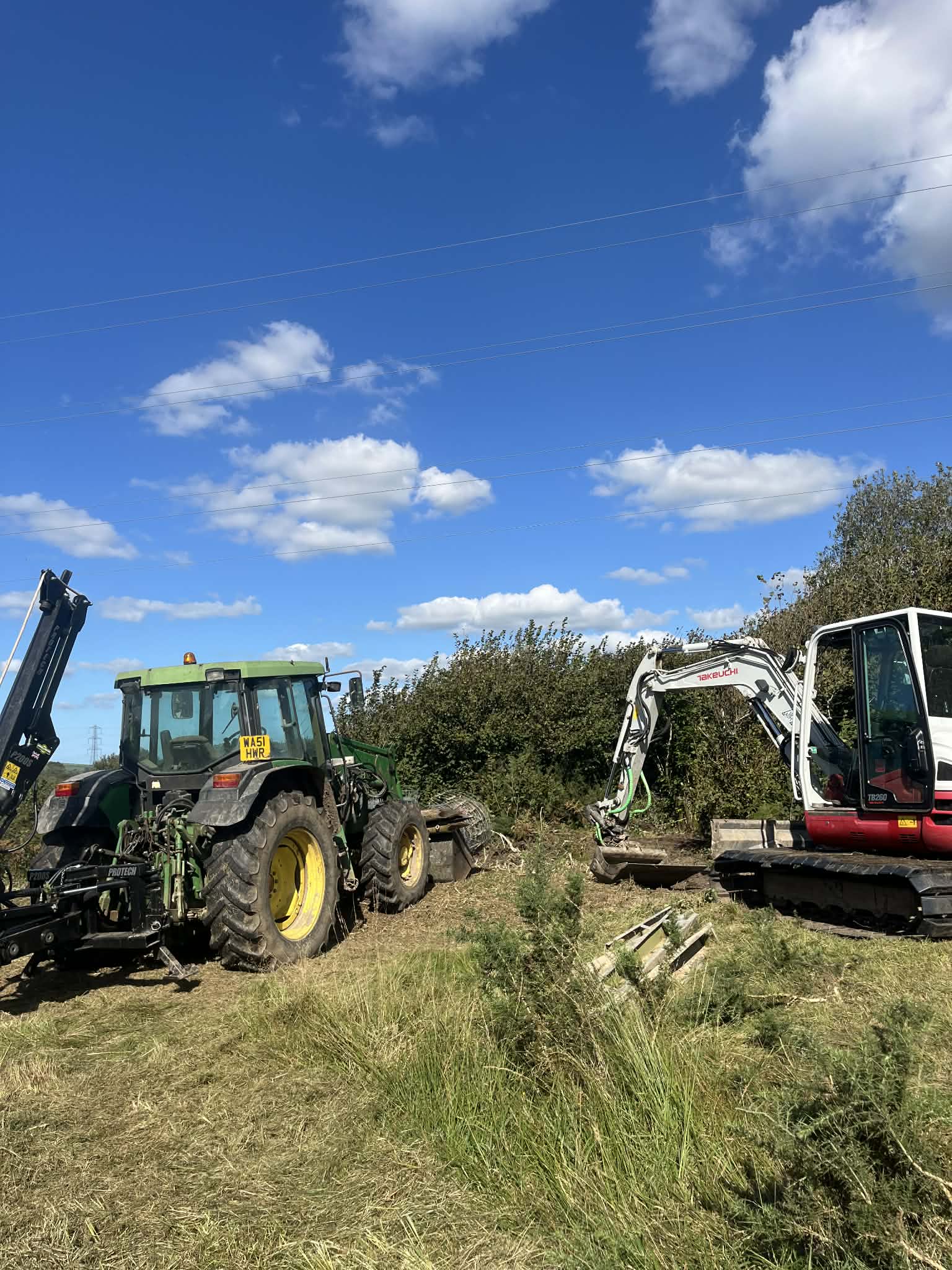 Machine work progress across rural Cornish terrain