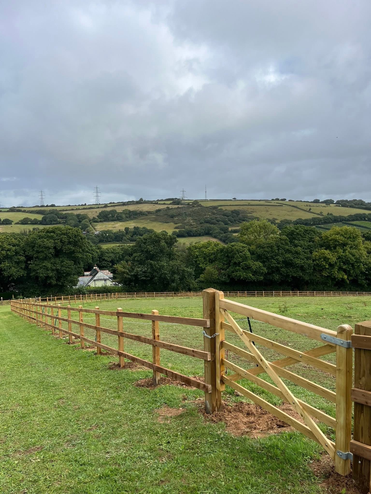 Post and rail fencing with timber field gate on a Cornwall farm